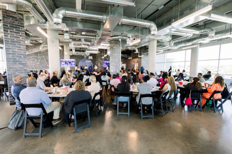 Corporate seminar with attendees seated at tables in Dallas–Fort Worth